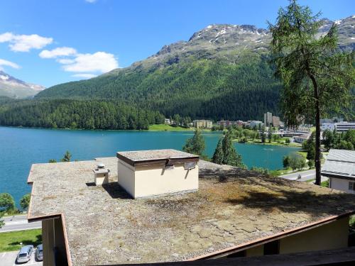 a building on a roof with a view of a lake at Apartment Chesa Sonnalpine B 46 by Interhome in St. Moritz