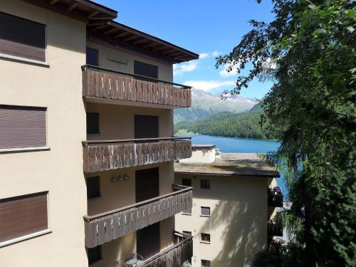 a view from the balcony of a building with a lake at Apartment Chesa Sonnalpine B 46 by Interhome in St. Moritz