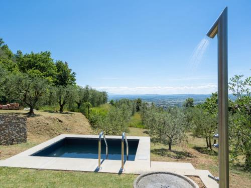 a swimming pool on top of a hill with trees at Holiday Home Nido del Sorbino by Interhome in Fondaccio