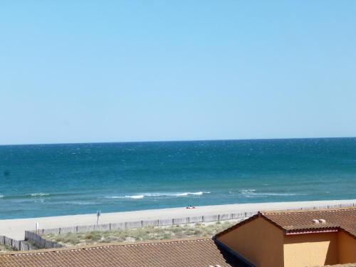 a view of the beach from the balcony of a condo at Apartment Les Flots Bleus by Interhome in Le Barcarès