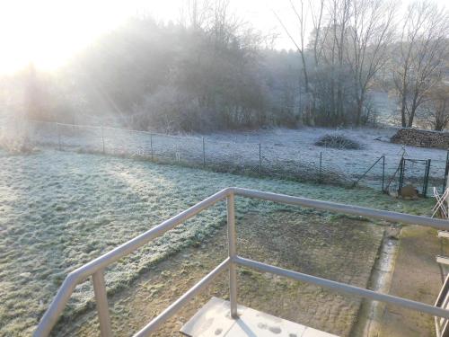 a fence in a field with snow on the ground at Gîte BELLA in Ebly