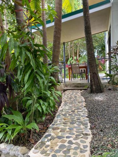 a stone walkway in front of a house at Casa Libertinn in Manuel Antonio