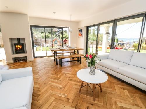 a living room with white furniture and a fireplace at Aquanaut in Cowes