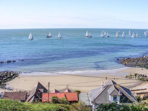 a group of boats in the ocean with sailboats at Aquanaut in Cowes