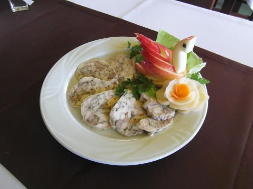 a white plate with food on a table at Usługi Hotelowe Podlasie in Biała Podlaska