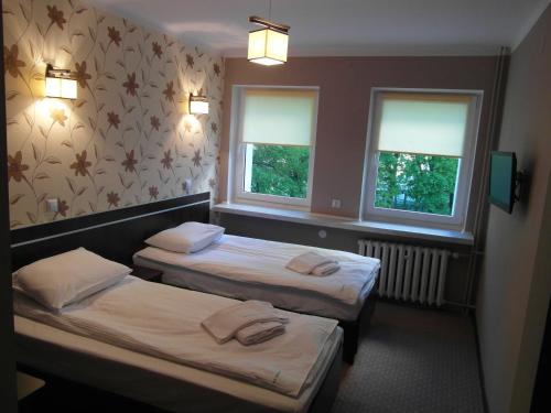 מיטה או מיטות בחדר ב-Usługi Hotelowe Podlasie