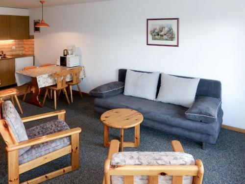 un soggiorno con divano, sedie e tavolo di Studio Hameau D12 by Interhome a Thyon-Les Collons