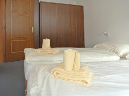 two beds with towels on them in a hotel room at Apartment Residenza Chesa Margun 46-3 by Interhome in Surlej