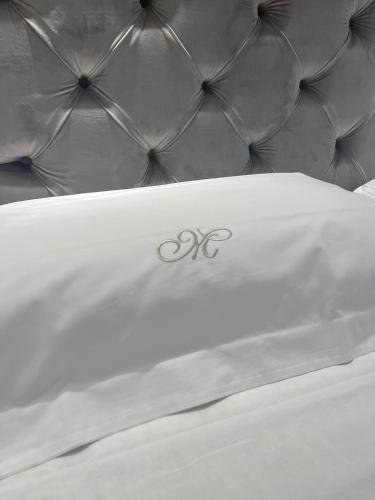 a close up of a bed with the olympics on it at Minori Palace De Luxe Apartment in Minori