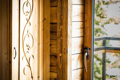 a wooden door in a room with a window at Willa u Steni in Gliczarów