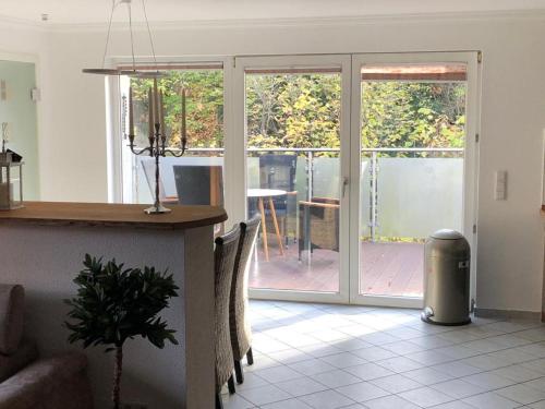 a kitchen with a sliding glass door to a patio at Ferienwohnung Black Beauty in Wernigerode