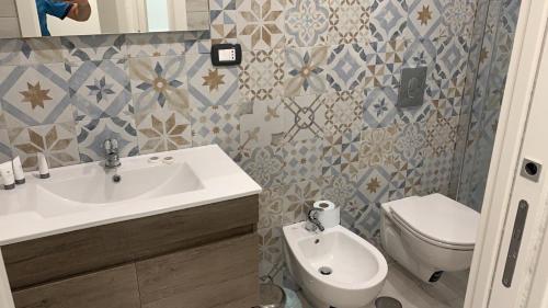 a bathroom with a sink and a toilet at Little Dreams Apartment in Trani