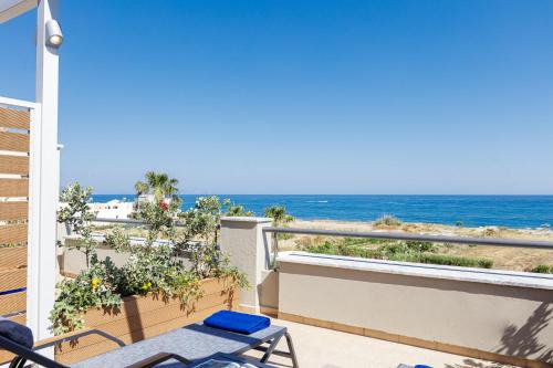 a balcony with a view of the ocean at Adele Riva in Adelianos Kampos