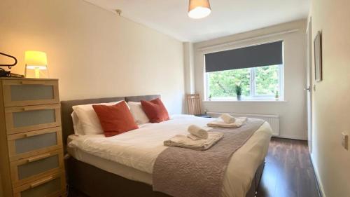 a bedroom with a bed with towels on it at 1Bed Apt in Stretford Close to Transport Links in Manchester