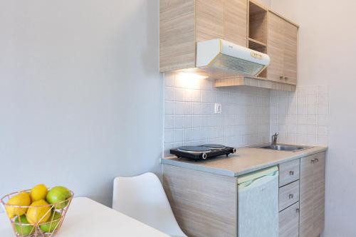 a small kitchen with a sink and a stove at Adele Riva in Adelianos Kampos