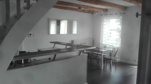 a kitchen and dining room with a table and chairs at Git'a'Gnac in Retournac