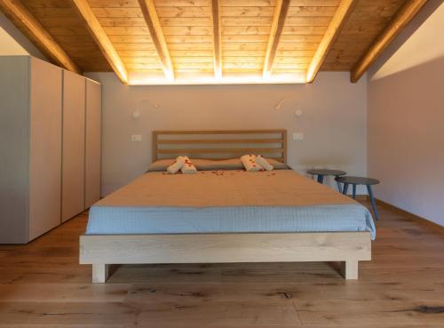 a bedroom with a bed with two dogs on it at Cà Piodèe in Faggeto Lario 