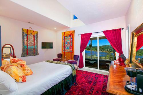 a bedroom with a bed and a large window at Quiet Mind Mountain Lodge, Retreat & Spa in Julian