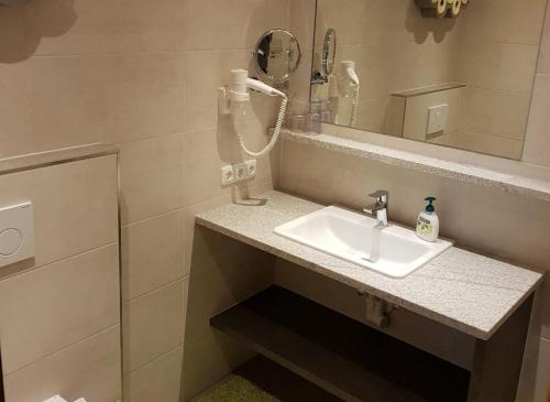 a bathroom with a sink and a mirror at Haus Talblick in Pettneu am Arlberg