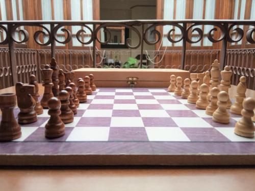 a chess set on a chessboard on a table at Hotel Rural La Vida de Antes in Consuegra