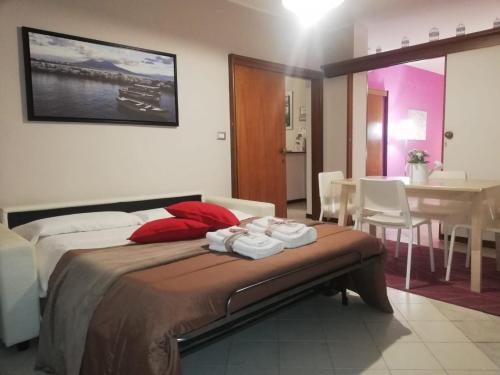 a bedroom with a bed and a dining room with a table at B&B Casa William in Castellammare di Stabia