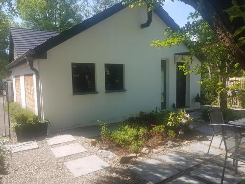 a white house with black windows and a patio at L'Atelier in Spa