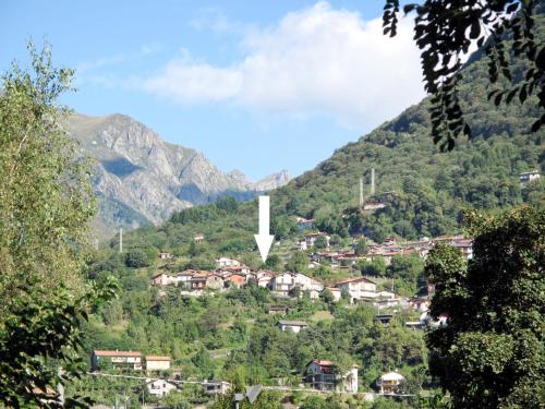 a village on a hill with a white arrow on it at Apartment Laura - DMA320 by Interhome in Vercana