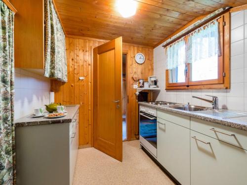 eine Küche mit Holzwänden und einer Holzdecke in der Unterkunft Apartment Eigersonne by Interhome in Wengen