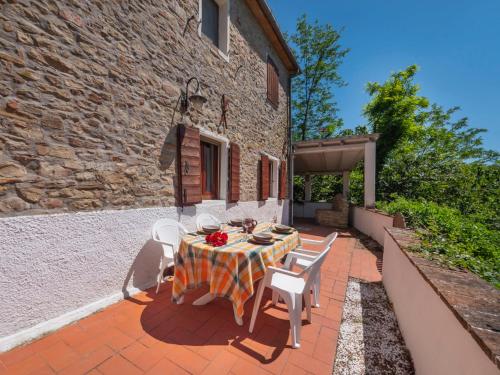 a table and chairs on the patio of a building at Holiday Home Casale Antica Pietra by Interhome in Gemmano