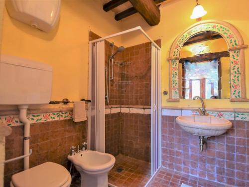 a bathroom with a toilet and a sink and a shower at Holiday Home Casale Antica Pietra by Interhome in Gemmano