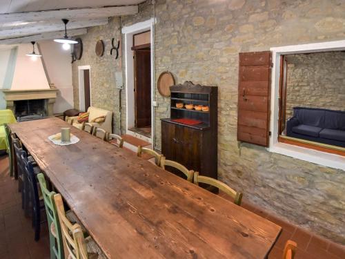 a dining room with a wooden table and chairs at Holiday Home Casale Antica Pietra by Interhome in Gemmano