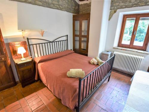 a bedroom with a bed with a red comforter at Holiday Home Casale Antica Pietra by Interhome in Gemmano