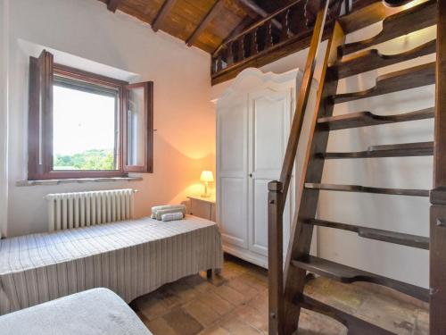 a room with a ladder and a bed and a window at Holiday Home Casale Antica Pietra by Interhome in Gemmano