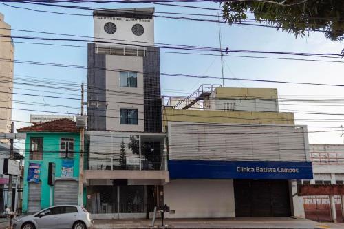 a building with a clock tower on top of it at STUDIO 302 | WIFI 600MB | RESIDENCIAL JC, um lugar para ficar. in Carmo