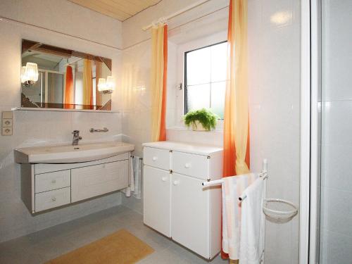 a white bathroom with a sink and a window at Apartment Eisele by Interhome in Kirchberg bei Mattighofen