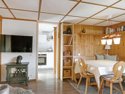 a kitchen and dining room with a table and a fireplace at Chalet Zwärgli by Interhome in Wengen