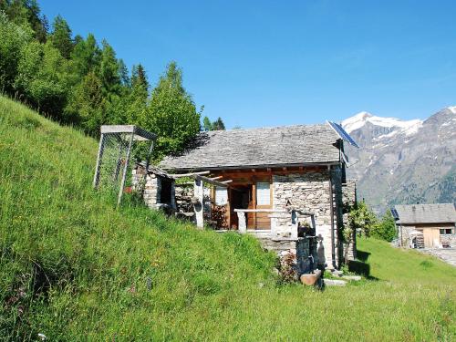 an old stone house on a hill in a field at Holiday Home Rustico Pamela by Interhome in Chiavasco