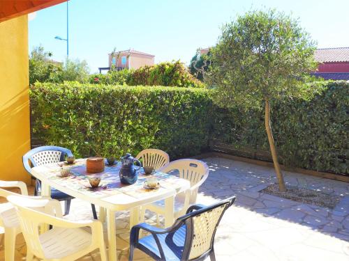 a white table and chairs on a patio at Holiday Home Plein Sud by Interhome in Narbonne-Plage