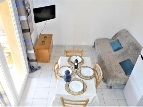 a living room with a table and a couch at Holiday Home Plein Sud by Interhome in Narbonne-Plage