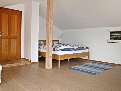 a bedroom with a bed with a pole at Holiday Home große Winten by Interhome in Geinberg