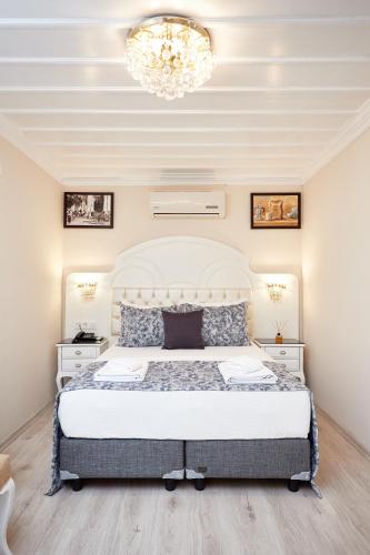a bedroom with a bed and a chandelier at Mataraci Konak in Istanbul