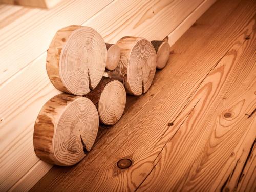 a bunch of wooden logs sitting on a wooden floor at Chalet Glockner-1 by Interhome in Heiligenblut