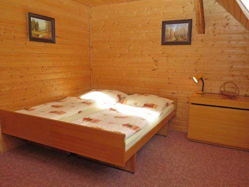 a bedroom with a bed in a wooden room at Holiday Home Lenora I by Interhome in Lenora
