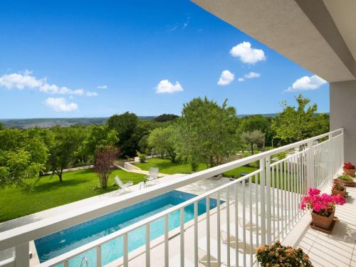 a view from the balcony of a house with a swimming pool at Villa Chiara by Interhome in Diminići