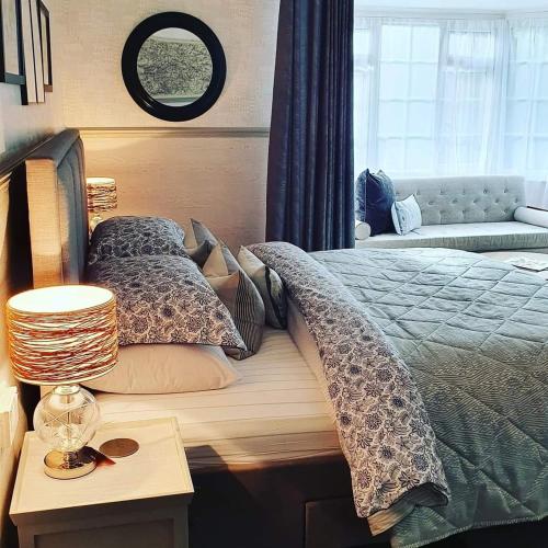 a bedroom with a bed and a table and a window at Rigsbys Guesthouse Doncaster in Doncaster