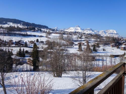 a winter view of a town with snow covered mountains at Studio Le Sapin by Interhome in Demi-Quartier