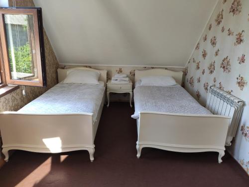 a room with two beds and a window at Fairy Tale in Gabala