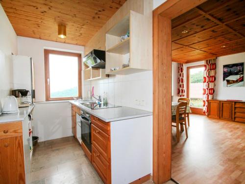 a kitchen with white appliances and a wooden ceiling at Apartment Ainhauser-1 by Interhome in Rodund
