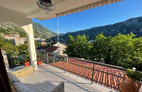 a balcony with a view of the mountains at Apartment Aki in Kotor