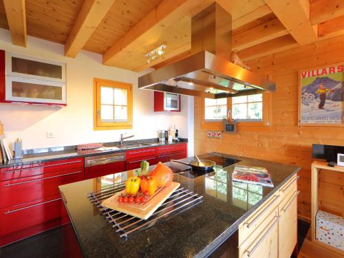 a kitchen with a counter with fruits on a cutting board at Chalet Chalet Maurice by Interhome in Chesières